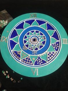 a blue and white clock with roman numerals on the face is surrounded by confetti