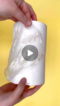 someone is holding a roll of toilet paper with a video playing on the top one