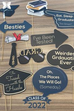 graduation party photo props on wooden table with class of 2021 signs and mortar stickers