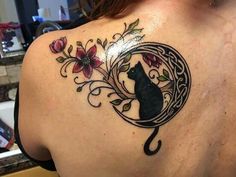 a woman with a cat tattoo on her back