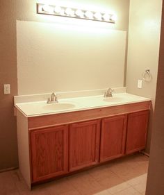 a bathroom with two sinks and a mirror