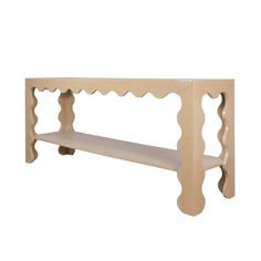 a wooden shelf with scalloped edges on the top and bottom, against a white background