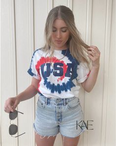 a woman wearing shorts and a usa t - shirt