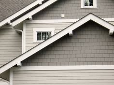 a gray house with white trim and windows