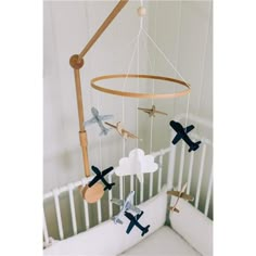 a crib with an airplane mobile hanging from it