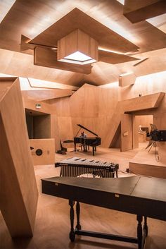 an empty room with piano and other musical instruments