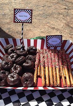 there are many donuts and other treats on display at this outdoor event in the park