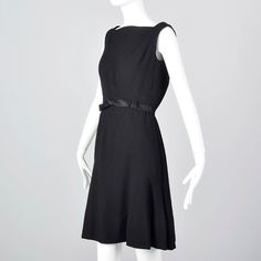 "The button-up back of this Adele Simpson piece adds a unique touch to this classic little black dress. Details: This listing is for one dress. Textile is unmarked, black wool crepe. Medium weight, good for evening wear. This dress has a back zipper and then buttons up with back. The back has a slightly loose style. Bow belt, slightly flared skirt. Size Marked: Unmarked Approximate Size: X-Small **Please Check Measurements to be Sure! Fabric: Unmarked Closure: Back Zip, Buttons Label: Adele Simp Classic Black A-line Vintage Dress, Black Fitted Sleeveless Vintage Dress, 1950s Style Sleeveless Evening Dresses, Classic Fitted Sleeveless Vintage Dress, Black Sleeveless Dress For Vintage Fashion, 1950s Sleeveless Vintage Party Dress, 1950s Style Sleeveless Vintage Party Dress, 1950s Style Sleeveless Vintage Dress, 1950s Black Vintage Evening Dress