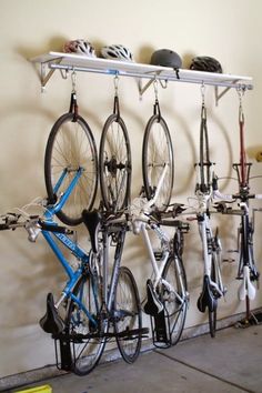 several bicycles are hanging on the wall