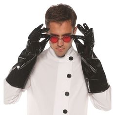 a man wearing black gloves and holding his hands up to his face with red glasses