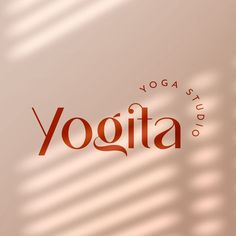 the yoga studio logo is shown in red and orange letters on a light colored background