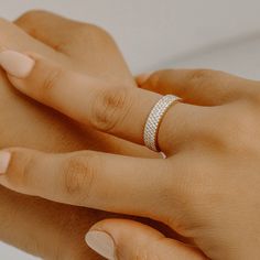 a woman's hand with a diamond ring on it