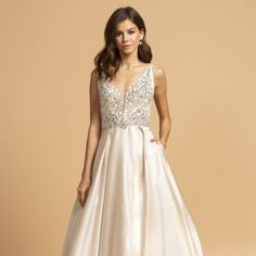 This Enchanting Gown Is Designed To Make You Feel Like A True Princess, Radiating Elegance And Sophistication At Any Special Occasion. The Skirt Of The Gown Is Layered, Adding Depth And Dimension To Your Overall Look. It Creates A Stunning Visual Effect, Making You Look Like You're Walking On Air. And The Best Part? It Even Comes With Pockets, Allowing You To Keep Your Essentials Close By And Adding A Modern And Practical Touch To The Dress. Length: Long Color: Champagne Neckline: Illusion Deep Formal V-neck Gown With Sheer Bodice, V-neck Gown With Sheer Fitted Bodice, Fitted Bodice V-neck Dress For Debutante Ball, V-neck Dress For Debutante Ball With Fitted Bodice, Satin V-neck Dress With Lace Bodice, V-neck Sweep Train Dress For Debutante Ball, Champagne V-neck Evening Dress With Fitted Bodice, V-neck Wedding Dress With Fitted Bodice For Debutante Ball, V-neck Wedding Dress For Debutante Ball With Fitted Bodice