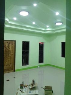 an empty room with green walls and white floors is shown in the middle of construction