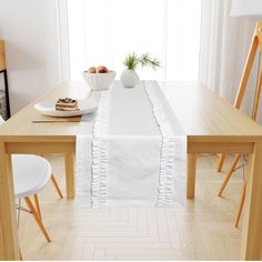 a white table runner with ruffled edges on a dining room table