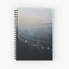 an aerial view of traffic on a highway in the foggy day spiral notebook journal