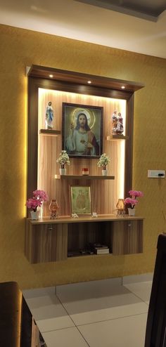 an image of the virgin mary on display in a wall mounted cabinet above a dining room table