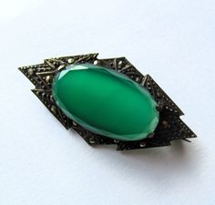 Art Deco Chrysoprase Sterling Marcasite Germany Antique Brooch Circa 1930 This is a beautiful antique Art Deco brooch, chrysoprase stone held in an a sterling and marcasite setting. Marked Sterling Germany on the reverse. Circa 1930's Measures 1 3/4 inches long and 7/8 of an inch wide Green Oval Brooches For Formal Occasions, Victorian Green Collectible Brooches, Antique Green Gemstone Brooches, Art Deco Green Brooches For Wedding, Green Art Deco Brooches For Wedding, Green Art Nouveau Wedding Brooches, Antique Green Brooches For Wedding, Art Deco Brooch, Antique Brooches