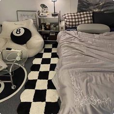 a bed room with a neatly made bed and a checkered rug on the floor