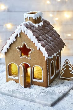 a gingerbread house is decorated with icing