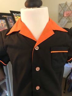 "Handmade in black cotton this little boys 1950s style Halloween bowling shirt has orange piped sleeve and pocket trim, dinky little side splits (just like the grown up ones), contrasting orange collar and cute pale orange buttons.  Chest- 25\" Length - 13\" Sleeve length- 4\"" Retro Black Top For School, Crystal Outfit, Halloween Bowling, Vintage Style Blouses, 1950’s Style, Rave Hair, Bowling Shirt, Pale Orange, Vintage Mens Fashion