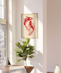 a painting hangs on the wall next to a potted plant in front of a window