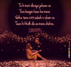 a man and woman sitting on the ground in front of some lights with a quote about love