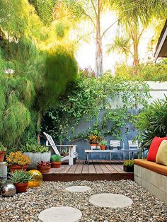 an outdoor patio with lots of potted plants on the side and a bench in the middle