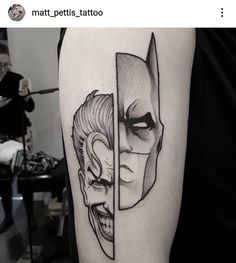 a man with a batman tattoo on his arm next to another person's face