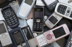 a pile of old cell phones sitting next to each other on top of a table