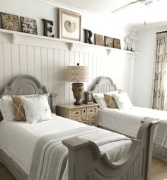 two twin beds in a bedroom with white walls