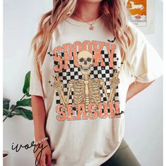 Trendy retro spooky season t-shirt for Halloween or fall. Skeleton print with a vintage checkered background on a comfort colors tee. To wear oversized, please size up. MATCHING YOUTH SHIRT HERE: https://www.etsy.com/listing/1538453547/kids-halloween-shirt-skeleton-tee?click_key=0bc0295aef0873ef3ac0987858ecb66c2f738307%3A1538453547&click_sum=58b6c300&ref=shop_home_active_1&pro=1&frs=1 Comfort Colors introduces its garment-dyed t-shirt;  made 100% with ring-spun cotton. The soft-washed, garment-d Halloween Preppy, Fall Skeleton, Fall Graphic Tees, Preppy Halloween, Retro Skeleton, Family Disney Shirts Matching, Halloween Shirt Design, Checkered Background, Halloween Shirts Kids