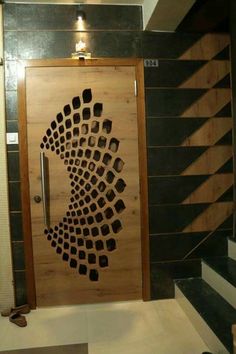 a wooden door with black and white designs on it