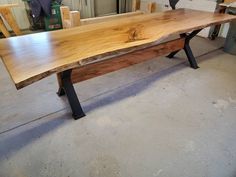 a wooden bench sitting inside of a garage