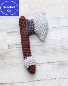 a crocheted dog bone laying on top of a wooden floor