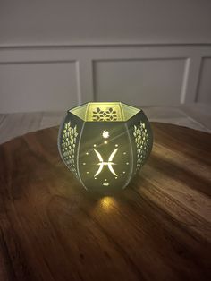 a small glass vase sitting on top of a wooden table