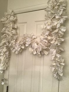 the door is decorated with white paper flowers