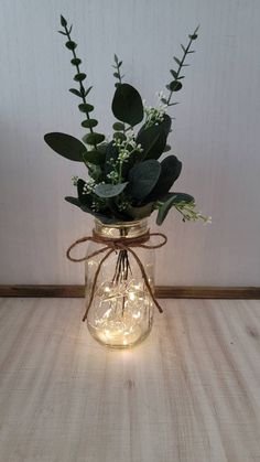 a mason jar filled with greenery and lights