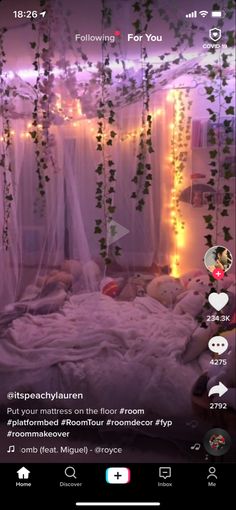 an image of a bedroom decorated with lights and greenery on the walls, bed in foreground