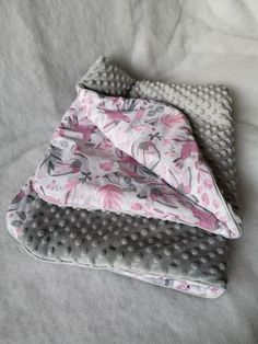 three pieces of cloth folded on top of each other with polka dots and pink flowers