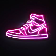 a neon nike shoe is lit up in the dark