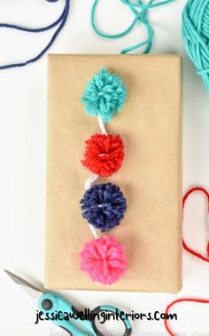 crochet pom - poms and yarn on a piece of brown paper