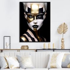 a living room with a white couch and black and gold art work on the wall