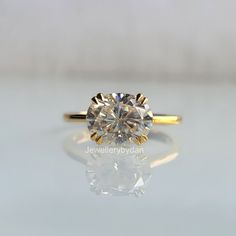 ♥ Capture her heart with this stunning East-West oval cut 2 ct colorless Moissanite engagement ring in 10K/14K/18K yellow gold. This solitaire ring makes a perfect wedding band or stackable ring. Delicate and unique, it's the perfect promise ring or anniversary gift for her, East-West Oval Cut, Colorless Moissanite, Solitaire Ring, Engagement Ring, Yellow Gold, Stackable Ring, Promise Ring, Anniversary Gift, Wedding Band. ♥ 𝗪𝗲 𝗢𝗳𝗳𝗲𝗿 𝗖𝘂𝘀𝘁𝗼𝗺 𝗙𝗿𝗲𝗲 𝗘𝗻𝗴𝗿𝗮𝘃𝗶𝗻𝗴  Everything about this piece can be changed depending on your request. 18k /White/Yellow/Rose gold are all available.  Side stones and center Stone can always be upgraded or downgraded to suit your style.  Description and specifications: ♥ Design code: PEBSH-36 ♥ All Stone Details Type            :- Moissanite  We Sideway Oval Engagement Ring, East West Oval Engagement Ring, Stackable Wedding Ring, Gold Oval Engagement Ring, Stackable Rings Wedding, Ring Inspo, Moissanite Engagement Ring Solitaire, Engagement Rings Oval, Ring Promise