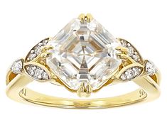 a yellow gold ring with an octagonal cut diamond surrounded by small white and clear stones