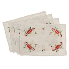 three white napkins with red berries and green leaves on the edges, one is folded in