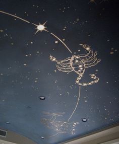 the ceiling is painted with gold paint and stars