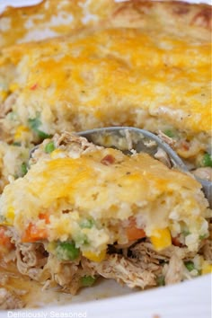 a close up of a casserole on a plate with a spoon in it