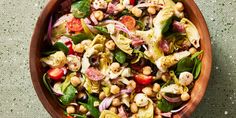 a wooden bowl filled with lots of food