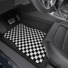 a black and white checkered floor mat in a car